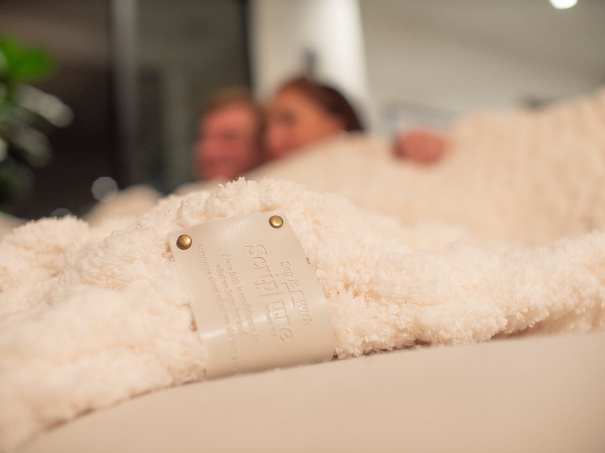 Cream blanket wrapped in branded tissue and ribbon